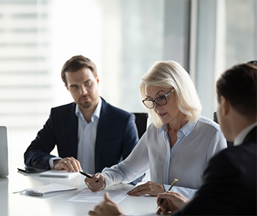 Concentrated aged businesswoman checking agreement